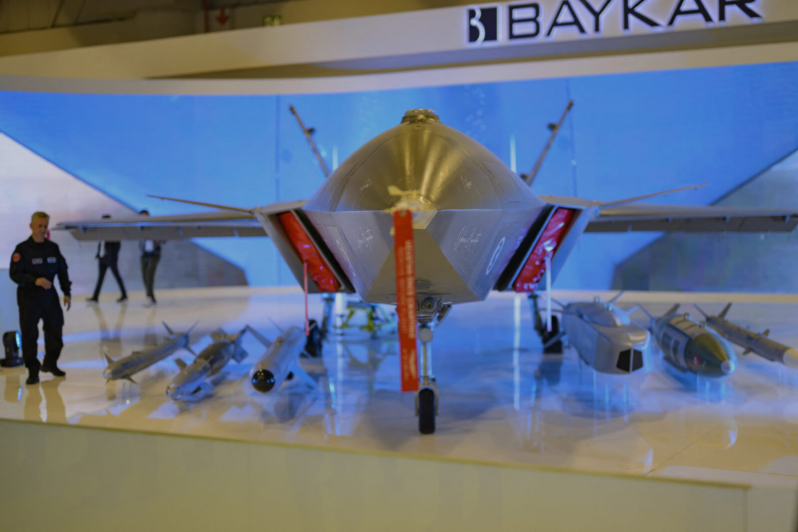 A member of staff walks near the Bayraktar Kizilelma UCAV