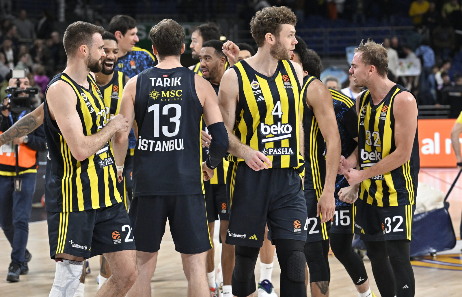 a group of men wearing black and yellow jerseys