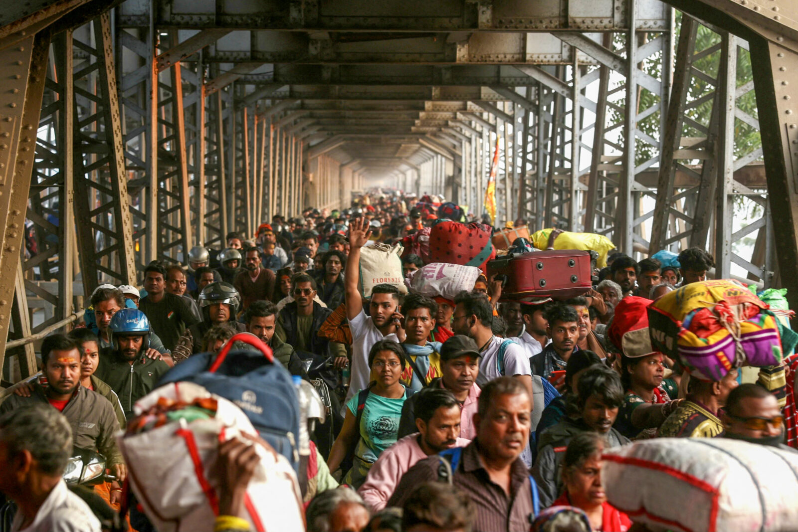 Hindu pilgrims seen walking along the old Yamuna bridge during the Maha Kumbh Mela festival.
