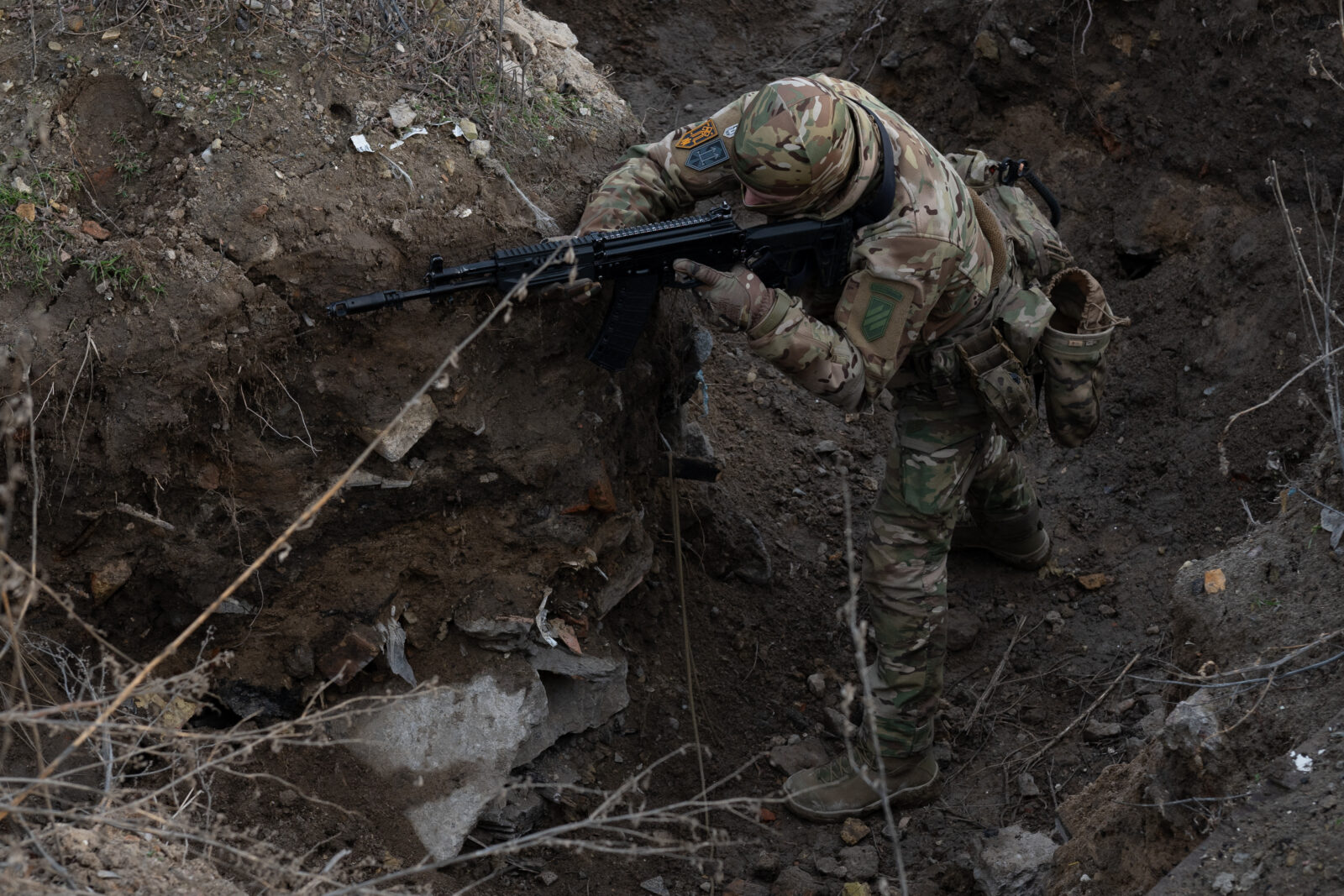 Photo shows a military instructor of the 3rd Assault Brigade trains civilians participating in trench warfare training during a 