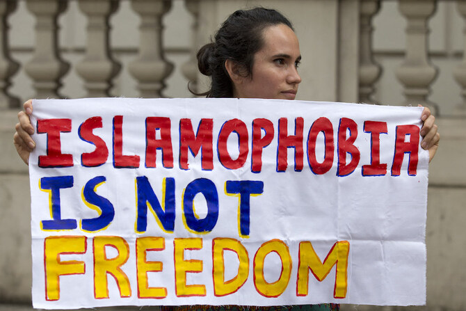Photo shows protester holds a sign which reads 