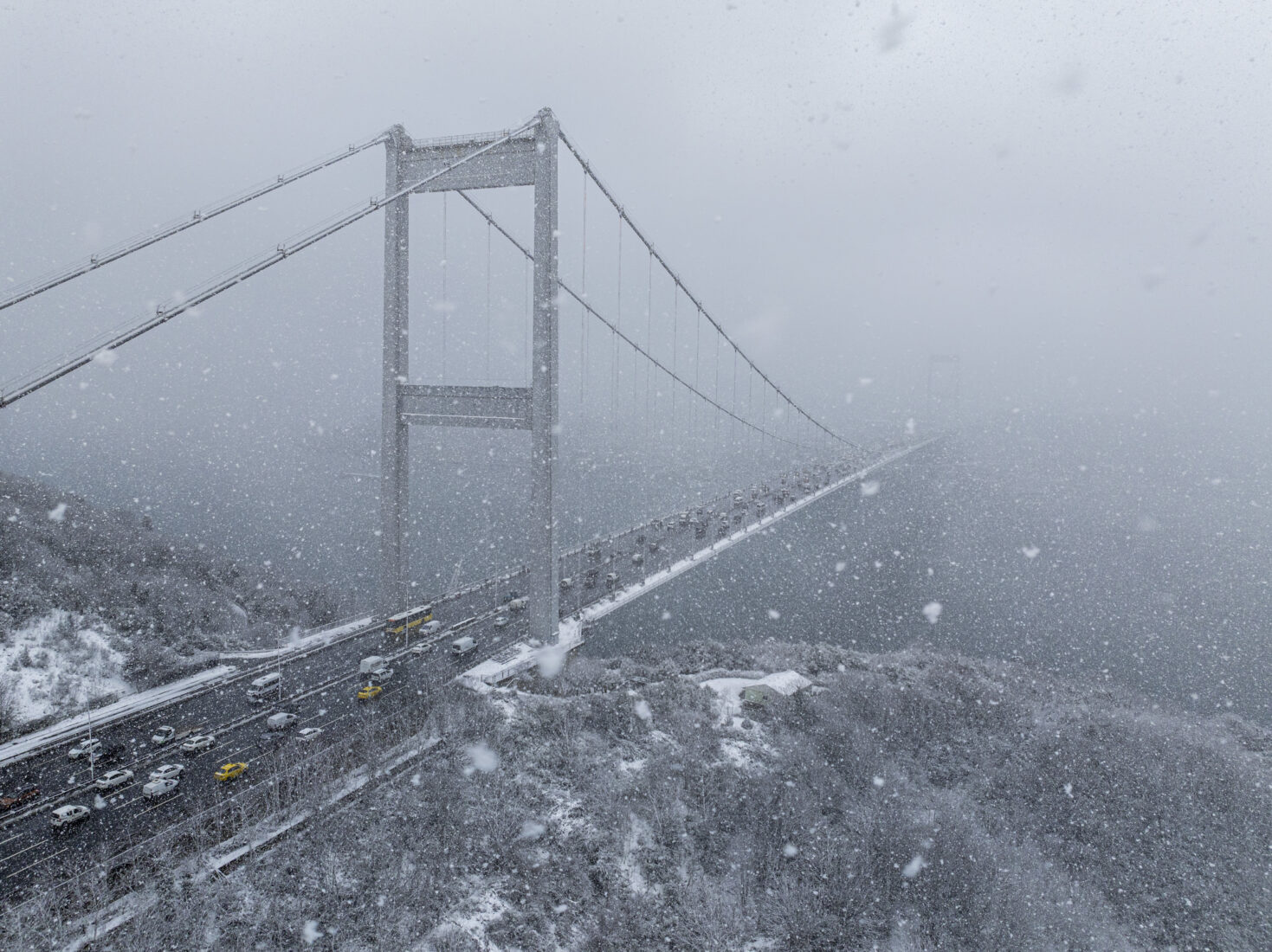 An aerial view of the Bosporus and its surroundings, blanketed in white as snowfall continues in higher areas of Istanbul.