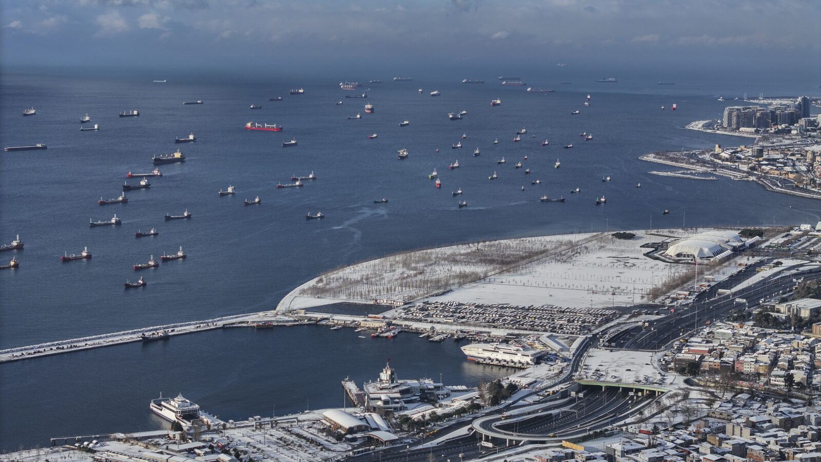 An aerial view of the Bosphorus ships as snowfall continues intermittently over Zeytinburnu, Istanbul.
