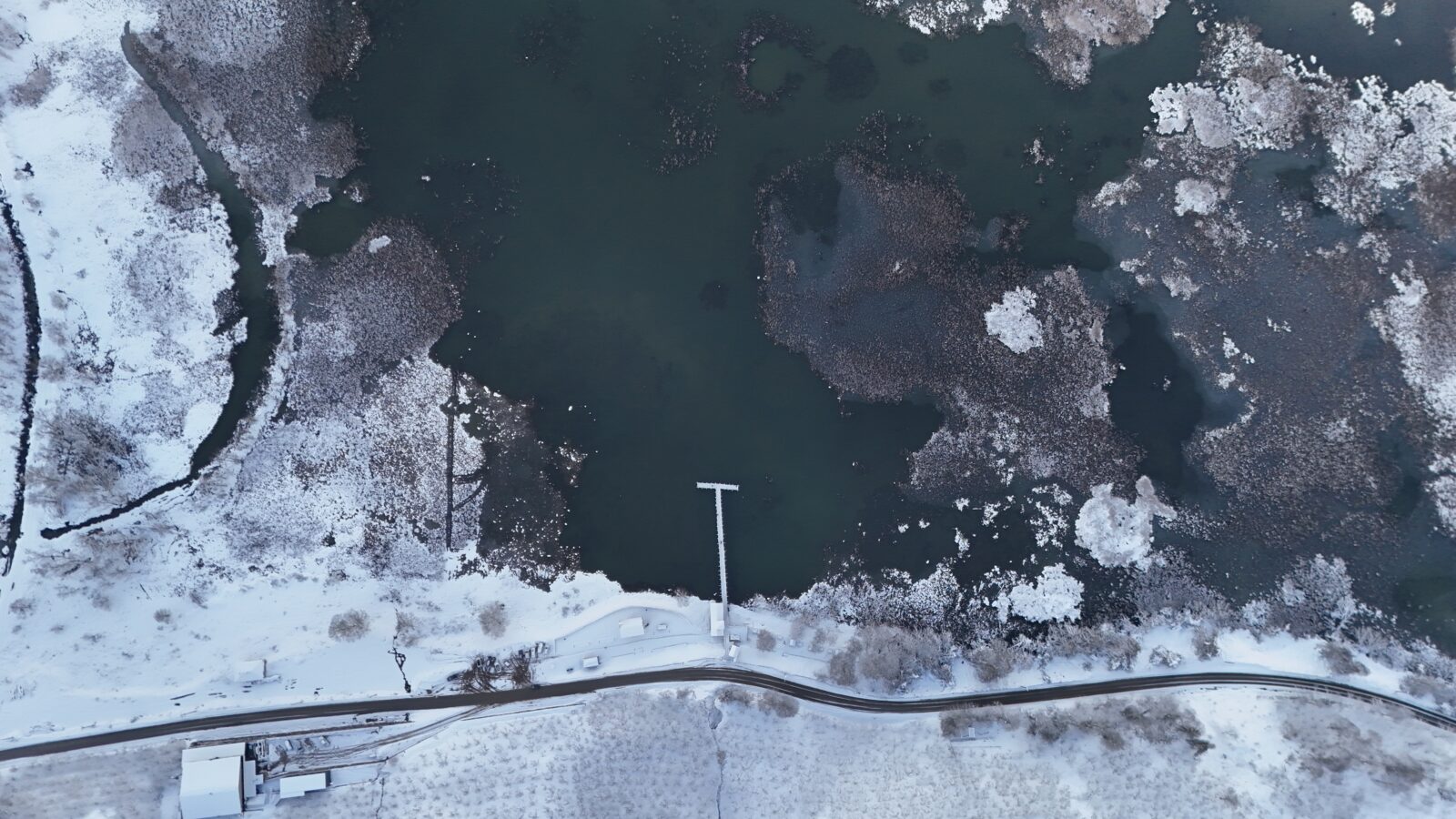 Aerial view of Efteni Lake with ice islets and snow-covered surroundings in Golyaka, Duzce, Türkiye.