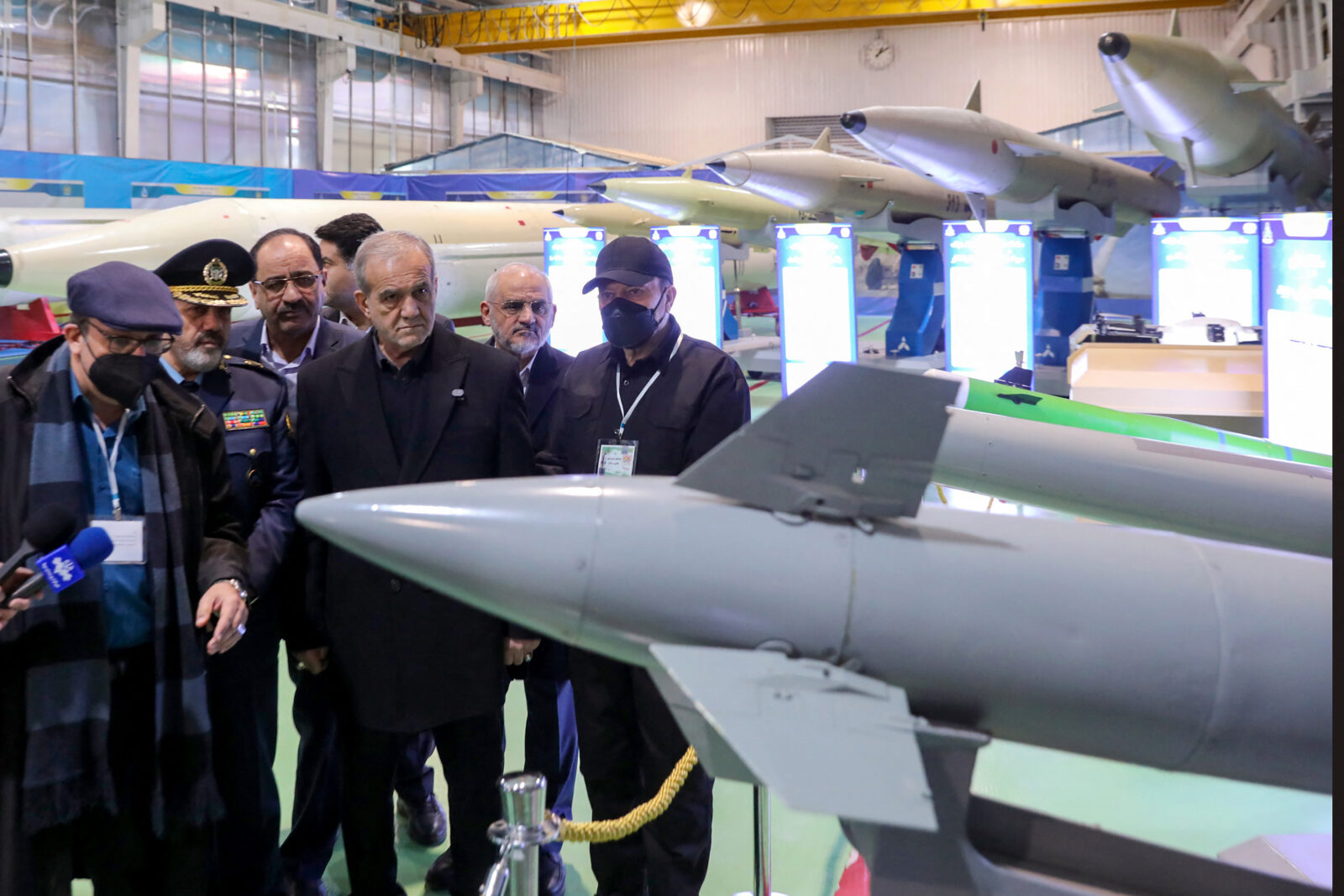 Photo shows Iran President Masoud Pezeshkian looking at a missile head