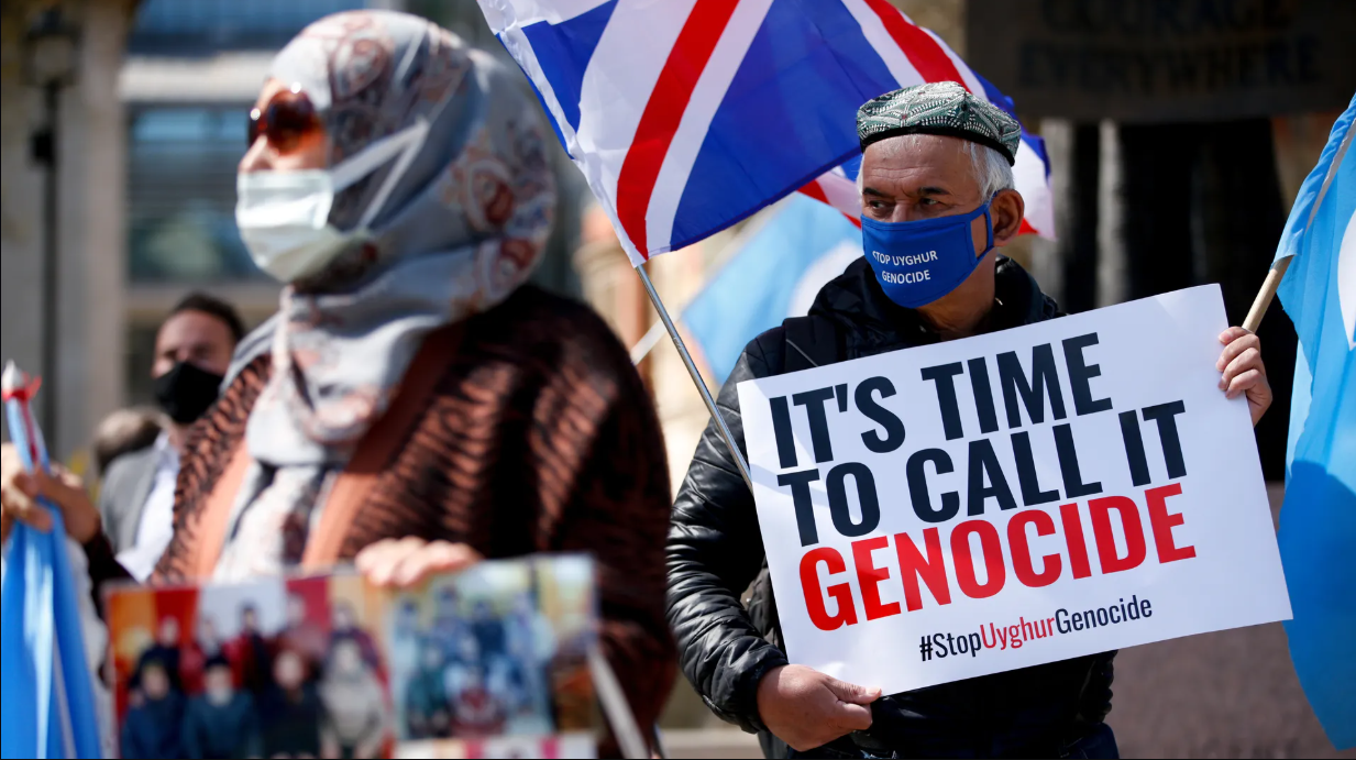 Photo shows uyghur diaspora carrying banner reading 