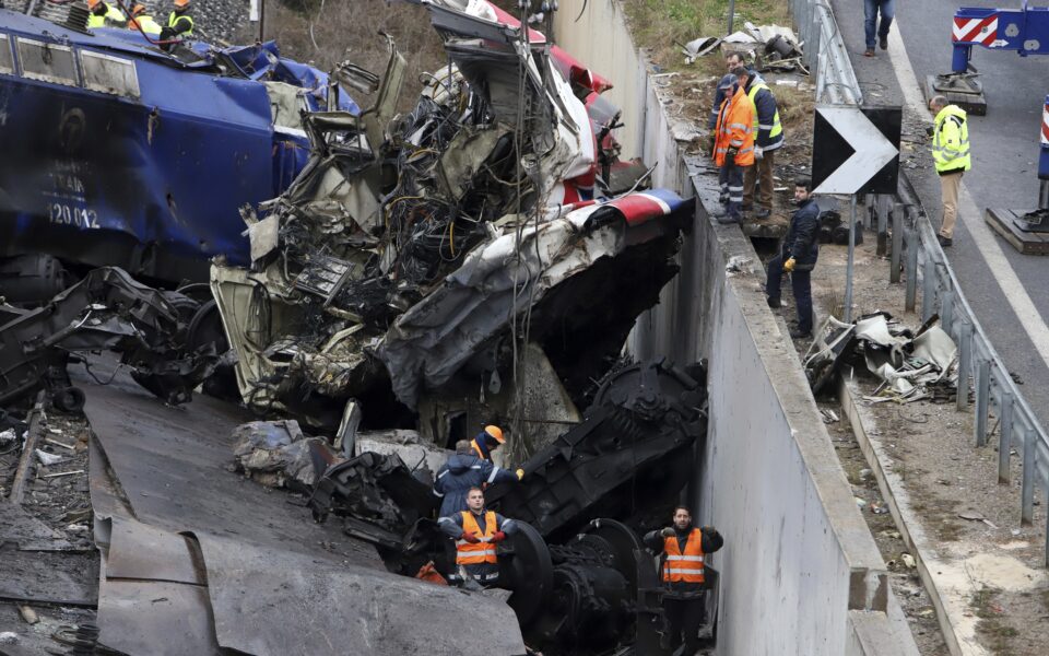 Rescue workers use a crane to clear debris from the tracks after a train collision in Tempi, approximately 235 miles (376 km) north of Athens, near Larissa, Greece