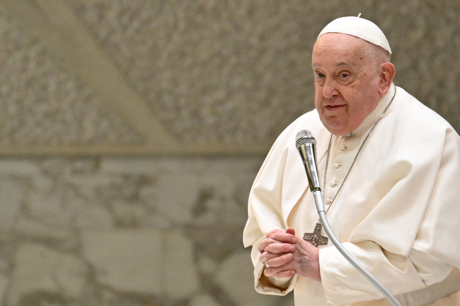 Pope Francis delivers a speech at the Vatican, showcasing his demeanor.