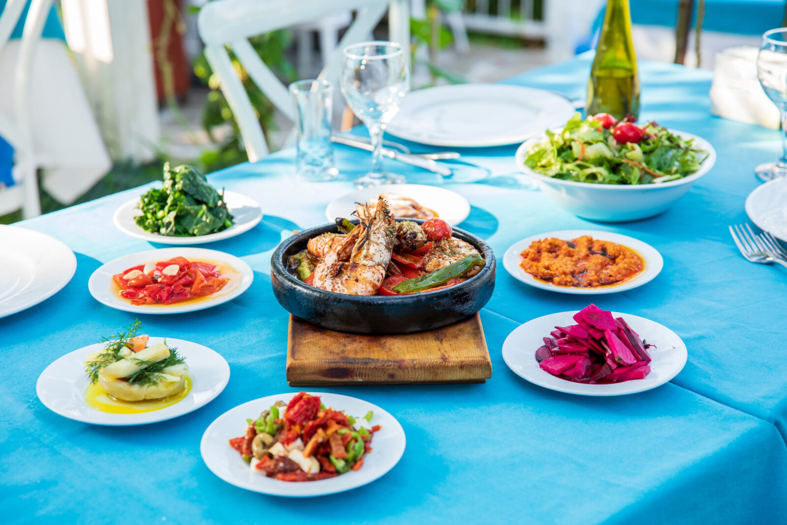 Shrimp, Seafoods, appetizers and salads on the table in Fish Restaurant in Turkey. Aegean seaside, Greek or Turkish style fish restaurant in Bodrum, Santorini or Mykonos