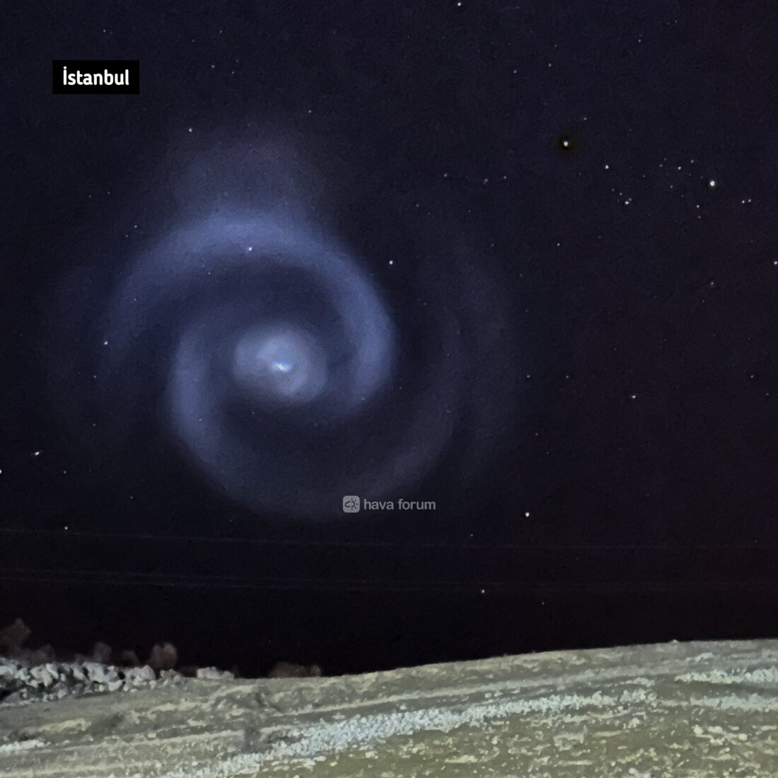 Photo shows spiral-shaped light seen in the sky.