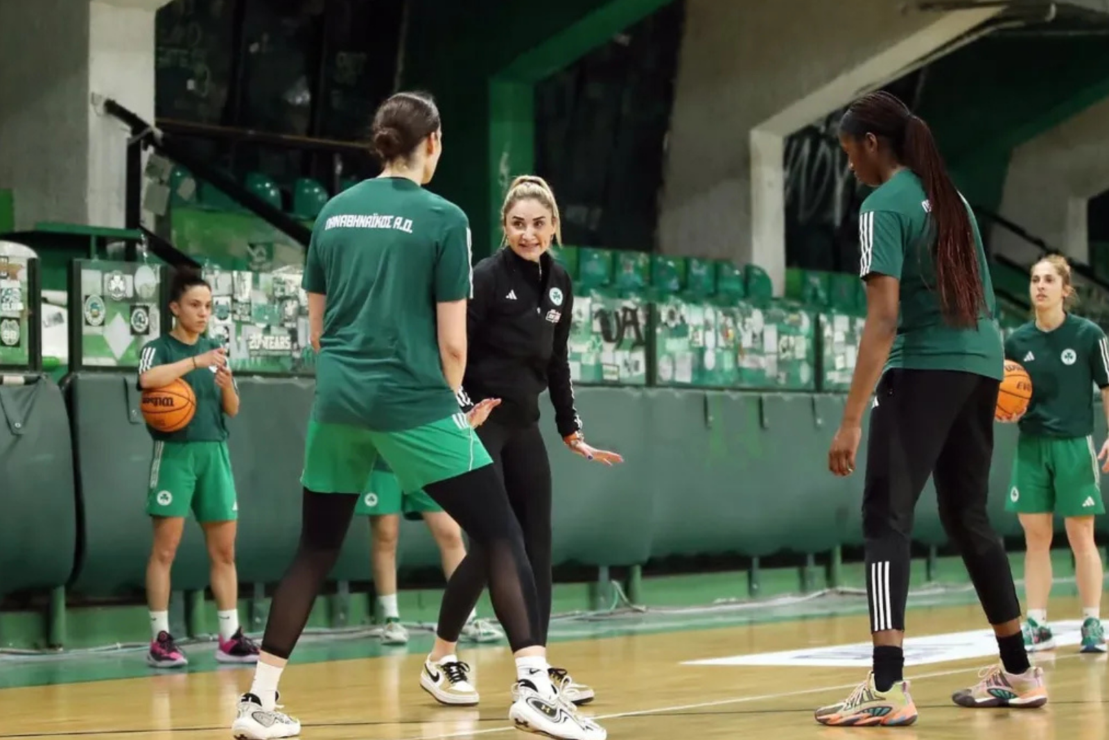 Turkish coach Selen Erdem working with her players during a basketball practice session.