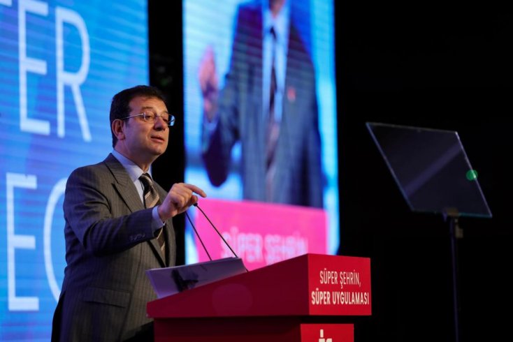 Photo shows former Istanbul Mayor Ekrem Imamoglu in front of a promotion board.