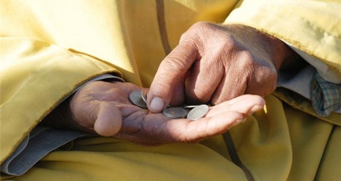 Elderly hand counting coins