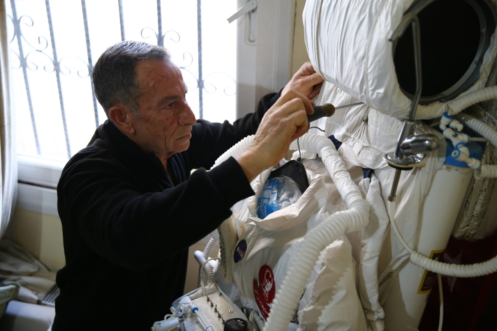tradesman Zeki Konuk wears an astronaut costume