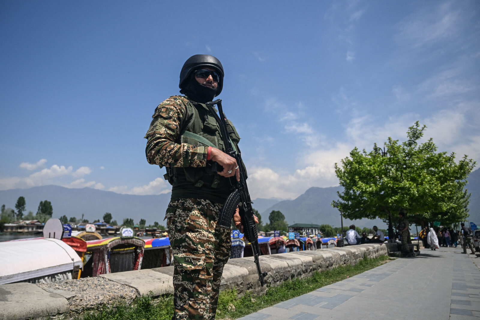 An Indian paramilitary trooper stands guard on the shores of Dal Lake in Srinagar