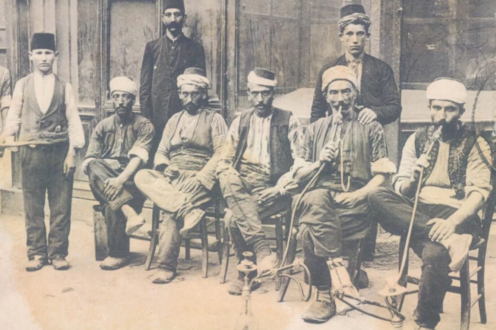 Porters smoking hookah in front of a coffeehouse,