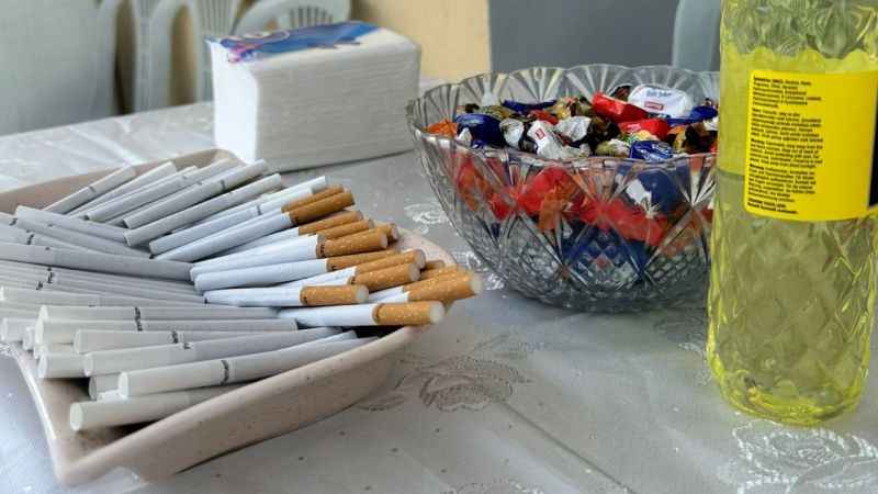 Cologne, candy and cigarettes on the table