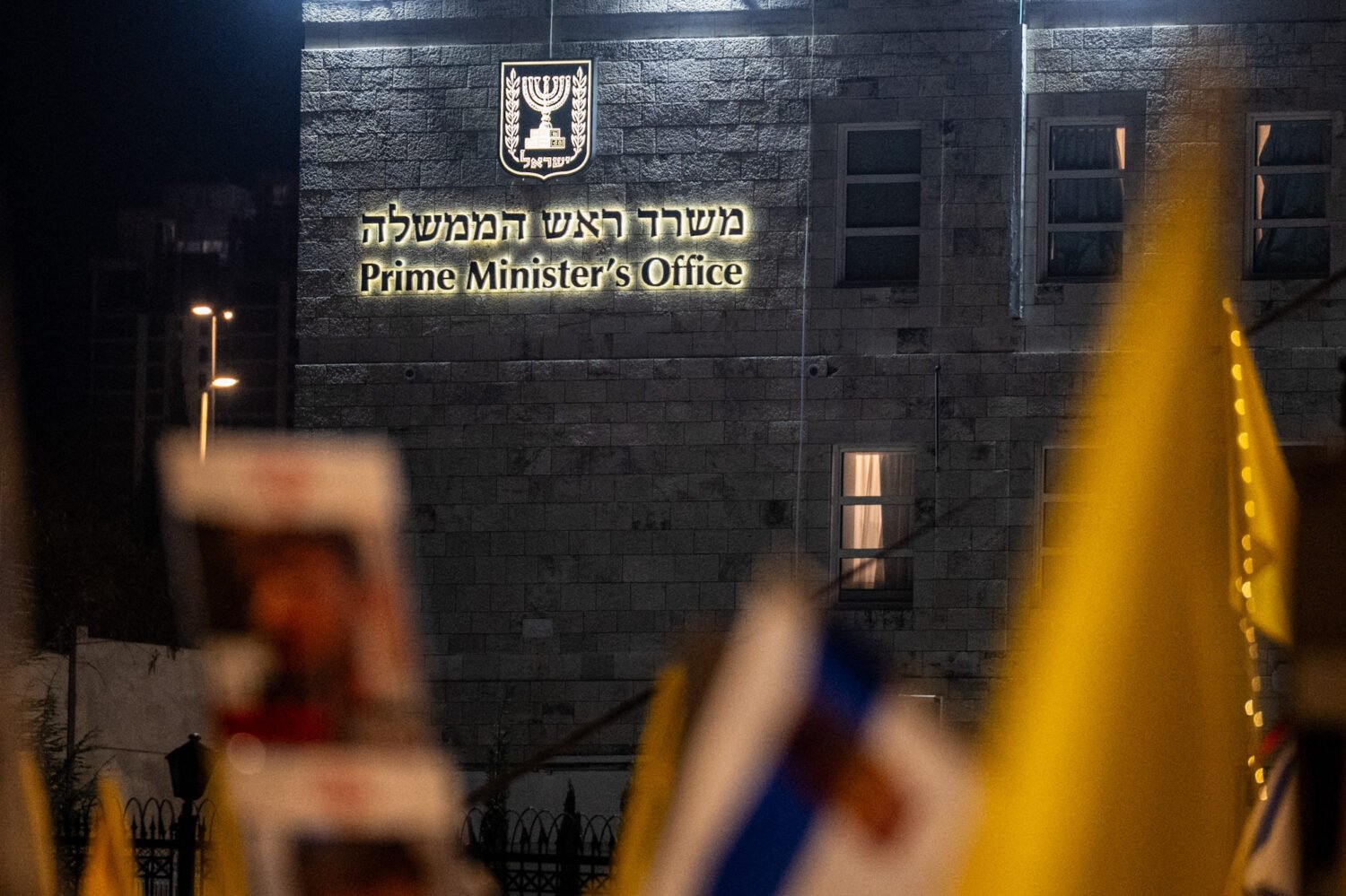 Israelis, holding Israeli flags, banners and chanting slogans